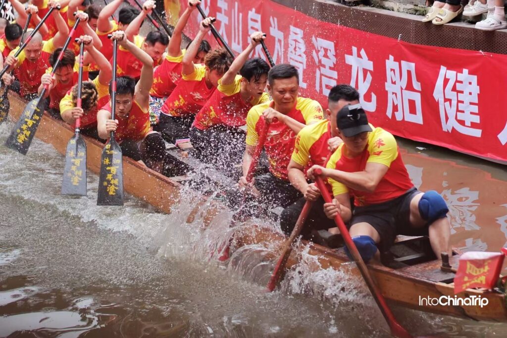 Dragon boat racing at Foshan Diejiao showing teams drifting through narrow village waterways during the Dragon Boat Festival