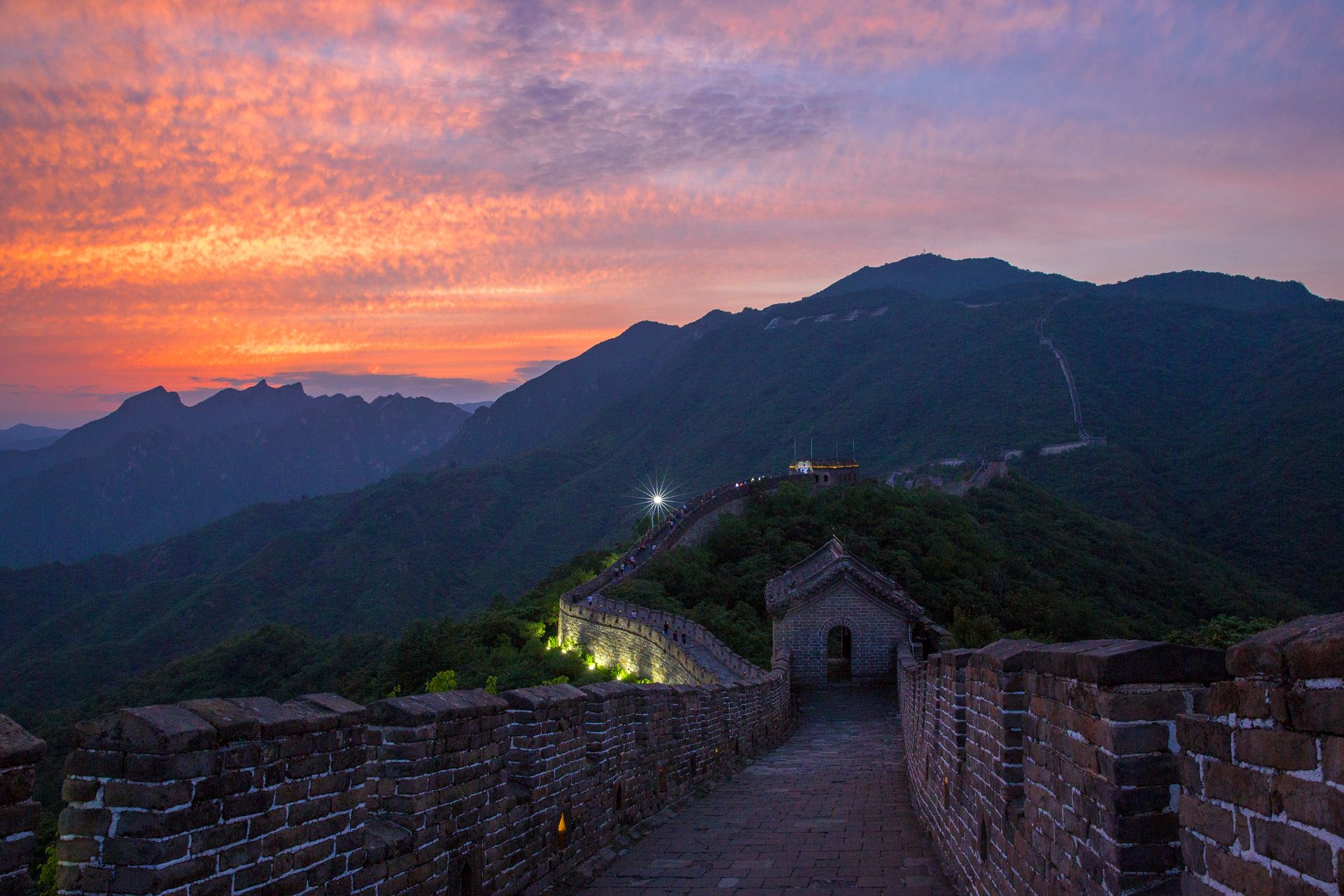 Great Wall of China at Mutianyu winding along mountain ridges during golden sunset