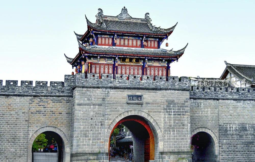 Narrow alleyway with historic buildings and red lanterns in Guanxian Ancient City, Dujiangyan
