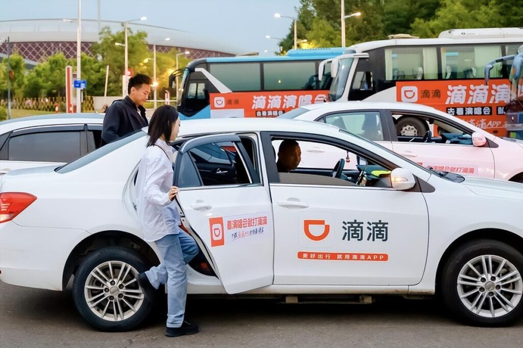 Didi ride-hailing app interface on smartphone showing car booking screen for tourists in China