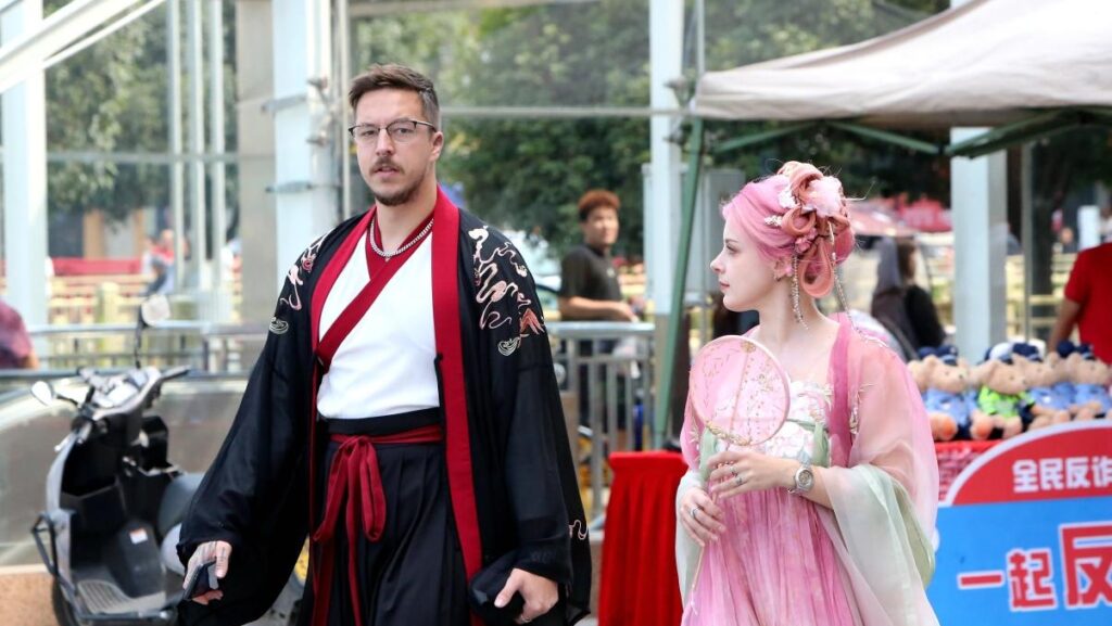 Foreign visitors wearing hanfu traditional Chinese clothing on a city street in China