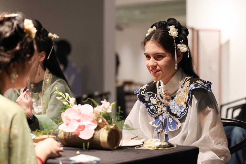 Foreign woman in elaborate embroidered hanfu with traditional hairpins at a cultural styling session