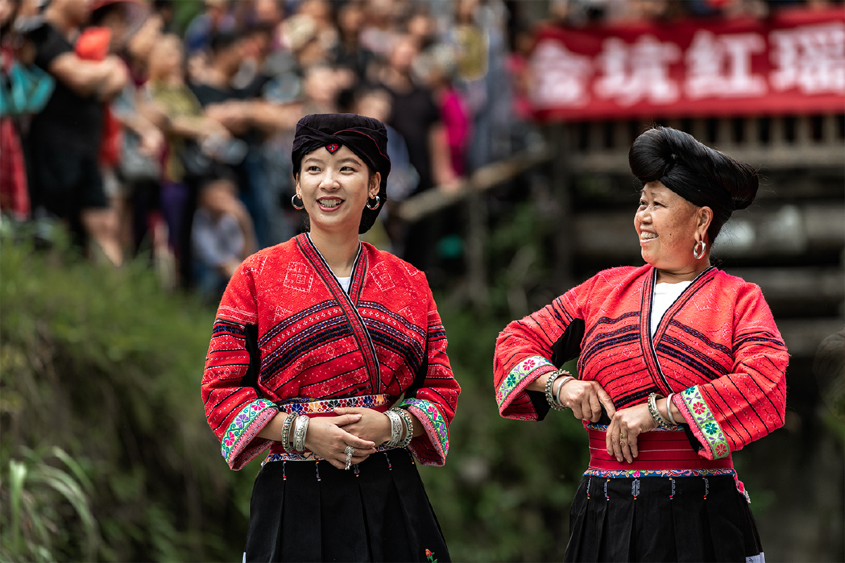 Yao ethnic minority women in traditional red embroidered clothing at Longji
