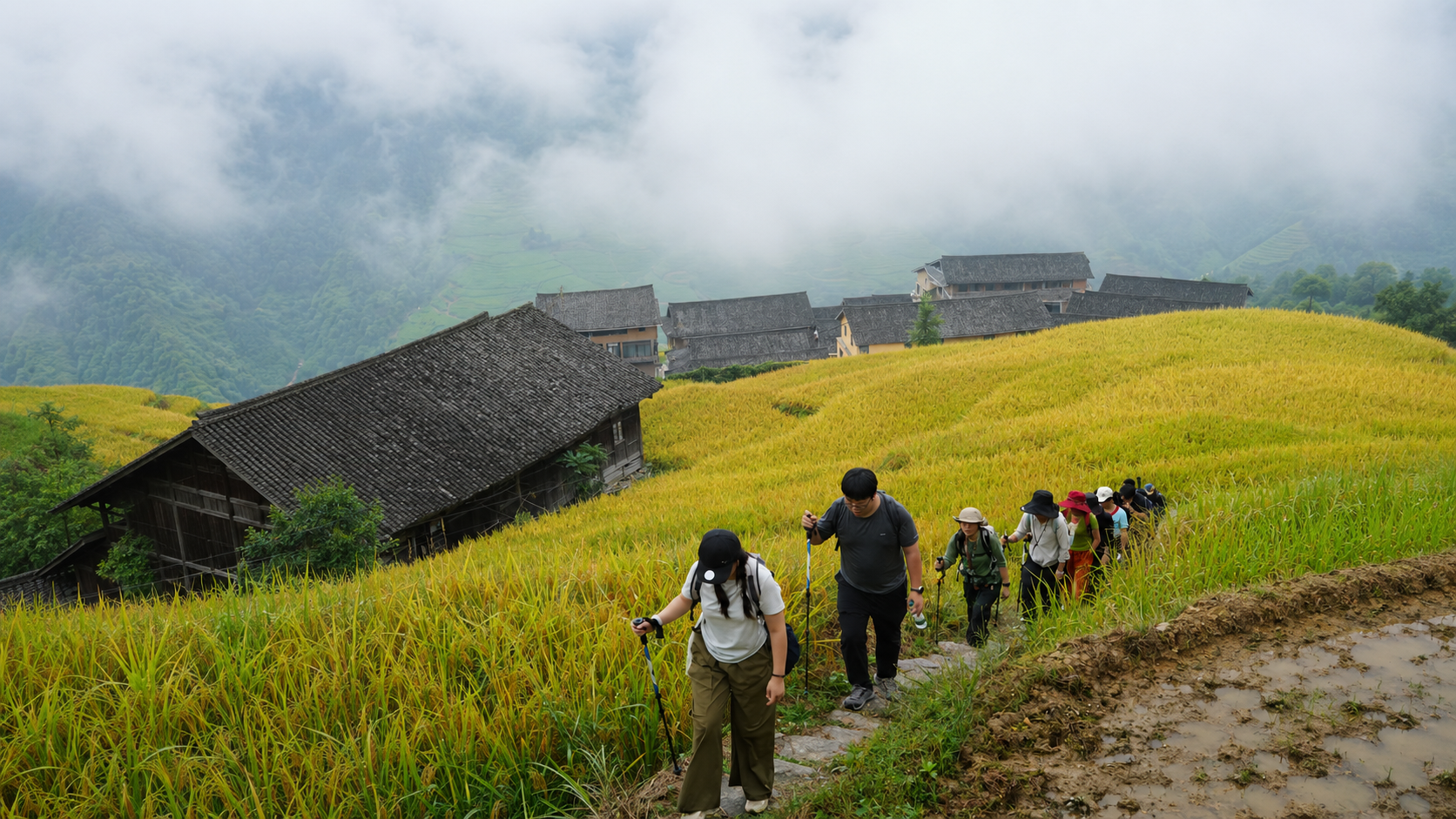 Trekking through Longji Rice Terraces past traditional Yao wooden houses
