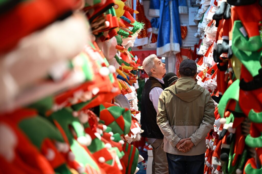 International buyers browsing Christmas decorations and festive supplies in Yiwu International Trade City