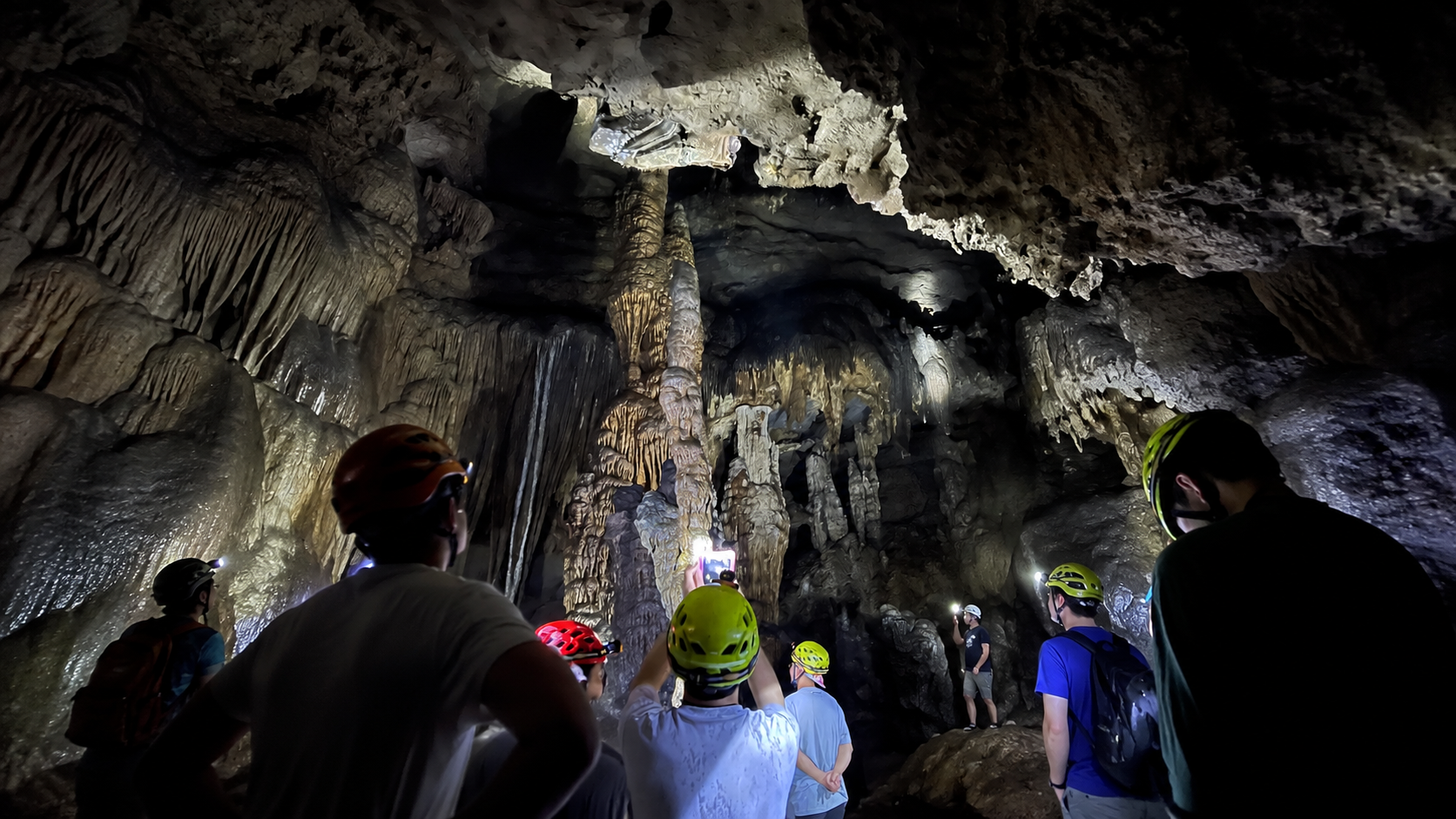 Caving expedition inside Moon Water Cave with illuminated stalactites and stalagmites, optional add-on for the Yangshuo Cycling and Via Ferrata Day Tour morning session