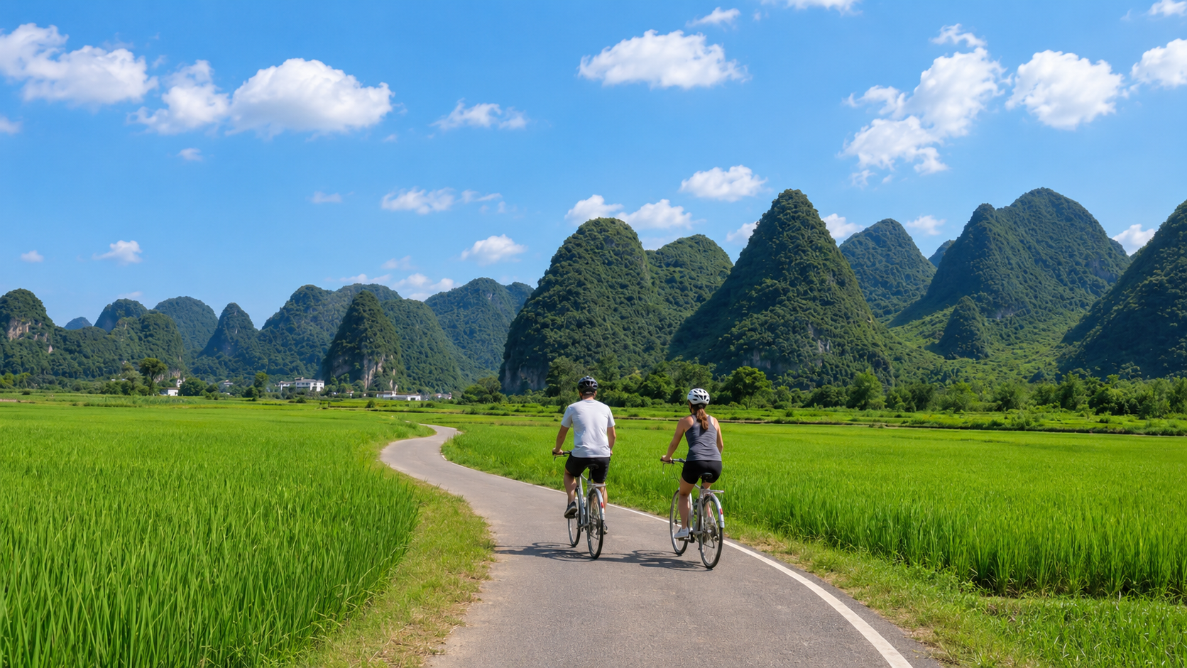E-bike cycling along the Yulong River Ten Mile Gallery with iconic karst peaks in the background, part of the Yangshuo Cycling and Via Ferrata Day Tour