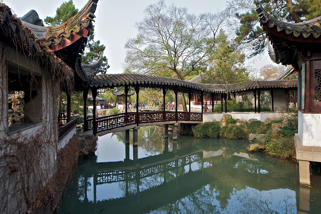 Flying Rainbow Bridge inside Humble Administrator's Garden — iconic covered walkway reflected in still water