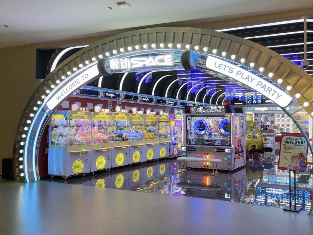 Arcade zone with claw machines inside a Chinese tangquan bathhouse entertainment hall
