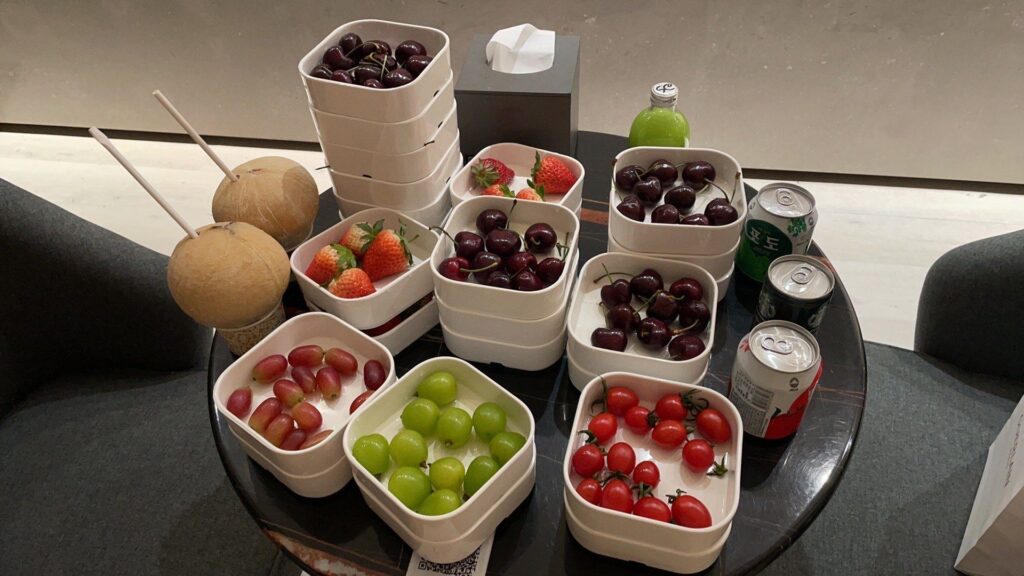 Free fruit and drinks included with a Chinese bathhouse ticket: cherries, strawberries, green grapes and coconut drinks