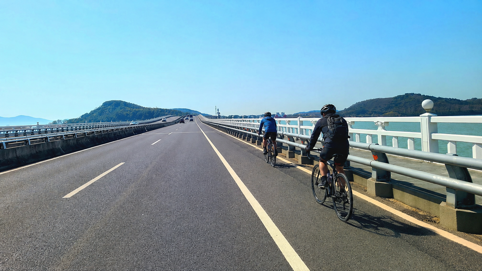 Cycling across the long Lake Tai bridge