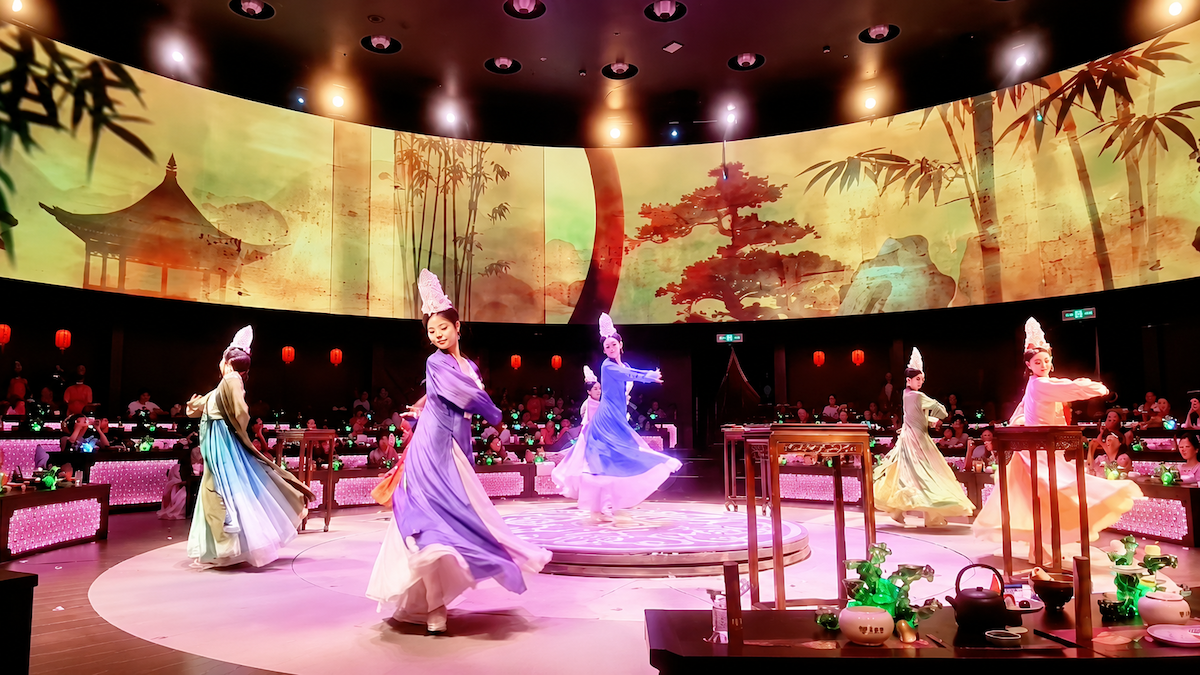360-degree rotating stage at Shanghai immersive dinner show with actors in Tang dynasty costumes performing around dining tables